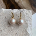 Detailed macro view of retro cotton pearl earrings with matte texture and gold plating - Beige (Cotton Pearl)