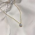 Vue détaillée d'un pendentif en zircon rond sur une fine chaîne plaquée or élégante - Doré