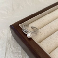 Detailed view of crisscross silver pearl ring with inlaid zircons in jewelry box - Shell Pearl Cross Micro-inlaid Ring / Silver