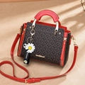 Red and monogram print satchel bag with daisy pendant and gold hardware details - Printed Red