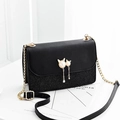 Black leather crossbody bag with glitter patchwork and golden cat pearl tassel detail - Black