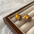 Detailed view of spherical enamel earrings with gold plating in a luxury jewelry box - Milk Tea (A-371)