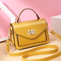 Modern bright yellow crossbody bag with matte leather finish and gold twist lock - Yellow