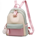 Pink and mint green patchwork nylon backpack with plush ball charm and FIDM text - Green
