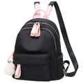 Black nylon backpack for women with pink straps and a white fuzzy pompom charm - Black