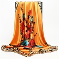 Detailed view of large satin scarf featuring orange floral patterns and leopard print edges - Orange Yellow (FT194-3)