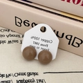 Macro view of brown enamel hemisphere earrings on white display card with retro style - Semicircle Studs (A-768) / Milk Tea (A-768)