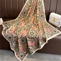 Detailed pattern of a vintage 90x90cm square silk scarf on a brown leather surface - Retro Brown Tan Mandala (FN82-3)