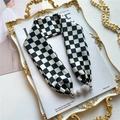 Detail of checkered silk scarf featuring a silver rhinestone ball pendant on a magazine - Black White Fashion Checkered Pattern (LN-9)