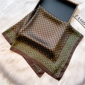 Detailed view of silk square scarf with horseshoe pattern on plush white surface - 70*70cm / Brown Green Horseshoe Print (FJ575-4)