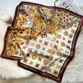 Detail of silk-like square scarf with intricate feather and floral patterns on plush rug - Wine Red Feather Geometric Style (FJ511-2)