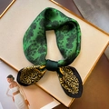 Elegant green silk scarf with floral and leopard prints tied in a bow on a white board - Green Floral Patchwork Leopard (FJ538-2)