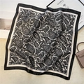 Close-up of vintage black and white paisley silk square scarf on a beige velvet surface - Black White Paisley (FJ537-9)