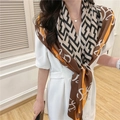 Detail of silk-like square scarf with vintage geometric prints on a model in white dress - Coffee Geometric Maze Letters (FE49-1)