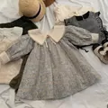 Flat lay of girl's puff sleeve floral dress in blue with polka dot collar and matching items - 90cm / Light Blue Floral