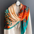 Detail of silk-like scarf with vibrant leaf patterns draped on a white suit jacket - Beige Orange Green Leaf (FE64-1) / 110X110CM