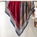 Detailed view of paisley silk scarf with color-block patterns hanging on a metal rack - Navy Red Coffee Paisley (FE103-2)