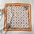 Detailed close-up of orange silk scarf with luxury monogram and feather motifs - Fj459-3 / 70*70cm