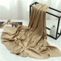 Close-up of champagne gold pleated scarf with elegant silk texture on a metal stand - Milky Camel (TH35-23) / 180x70cm