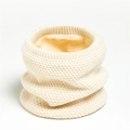 Detail of cream knit neck warmer showing thick waffle texture and soft fleece lining - Beige