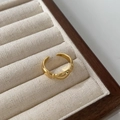 Detail view of gold-plated adjustable ring with minimalist streamlined knot design - Gold