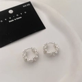Macro detail of silver lava wave textured hoop earrings on white ceramic plate - Matte Wave Texture Hoop (A-802)