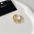 Close-up of elegant double-layered gold open ring with white pearls on ceramic tray - Gold Two-Pearl Open Style