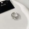 Macro shot of 925 silver double-layered open ring with two elegant white pearls - Silver Two-Pearl Open Style