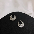 Detailed close-up of polished silver crescent hoop earrings on black leather texture - Flat Pleated Ear Buckle (Real Silver Plated) / Silver