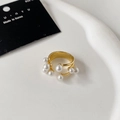 Detail of elegant gold layered open ring with white pearls on a minimalist white tray - Gold Multi-Pearl Open Style