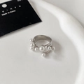 Detail of silver S925 open ring with multilayered white pearls on a ceramic tray - Silver Multi-Pearl Open Style