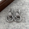 Detail of silver matte industrial multi-hoop earrings on knit texture background - Matte Silver Circle Ear Studs