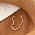 Macro detail of gold adjustable bracelet featuring sparkling pear-cut cubic zirconia stones - Gold