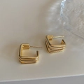 Detailed view of minimalist gold triple-layer geometric square earrings on warm beige background - Gold Triple Layer Square Hollow Style / Gold