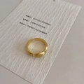 Macro shot of matte gold adjustable ring with beaded texture on white card - Gold Brushed Ring