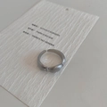 Macro shot of silver adjustable open ring with minimalist matte brushed metal texture - Silver Brushed Ring