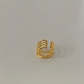 Macro detail of multi-layered gold plated interlocking rings with woven texture finish - Matte Gold