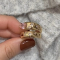 Detailed macro of gold ring featuring pink pear-shaped stone and star-shaped accents - Pink Zirconia / Gold