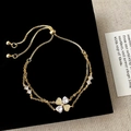 Adjustable gold plated bracelet featuring a zircon heart charm on a black velvet display - Gold