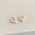 Macro shot of gold-plated heart earrings featuring pearlescent white enamel drops - White Oil Heart Style (A-852)