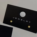 Detailed view of glossy gold sphere stud earrings displayed on a black jewelry card - Gold 3mm (Real Gold Plated)