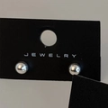 Macro shot of minimalist silver ball stud earrings on a black jewelry display card - Silver 6mm (Real Silver Plated)
