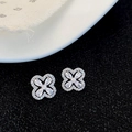 Macro shot of silver flower earrings with sparkling zircons on a textured black surface - Silver Zircon Flower Stud Earrings (Gold Plated)