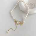 Detailed close-up of baroque freshwater pearl necklace with heart shell and golden OT buckle - Natural Freshwater Pearl Heart Shell OT Buckle Necklace