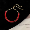 Detail of adjustable gold-plated tennis bracelet with square-cut red zircon stones - Red