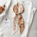 Gros plan d'un foulard en soie rétro français noué en nœud sur un haut blanc élégant - Toile de Jouy Marron Orange Crème Lettre V (LK32-V)