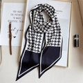 Macro shot of stylish houndstooth silk scarf with elegant watch and lipstick props - Black and White Houndstooth (LE-38)