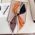 Detail of elegant geometric silk scarf with warm tones on a minimalist textured background - Color Block Geometric (LE-39)