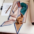 Detail of silk-like geometric scarf with pink and emerald colors on wooden tray - Elegant Color Block (LE-40)