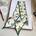 Flat lay of narrow floral silk scarf with orange prints on fashion magazine and accessories - 95x9.5cm / Citrus (LO-4)